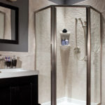 White corner walk-in shower with brushed nickel fixtures